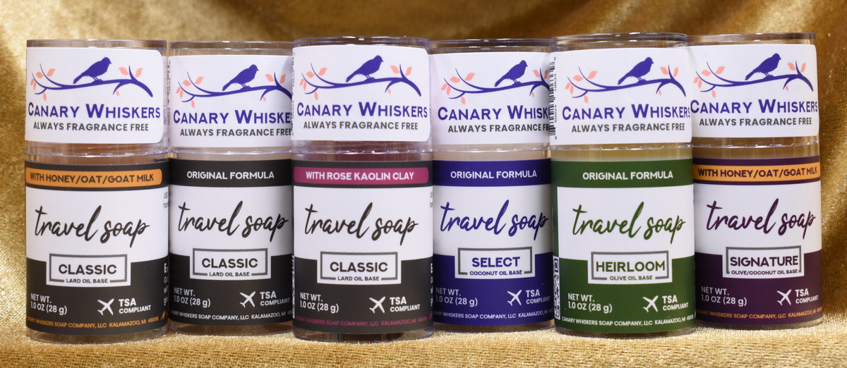 Six tubes of solid fragrance-free travel soap lined up for group photo.